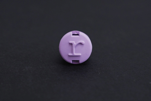 A photo of the Random plug, with raised lowercase letter r